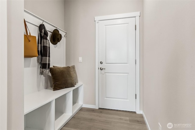 mudroom featuring baseboards and wood finished floors