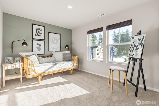 sitting room with carpet flooring, visible vents, and baseboards