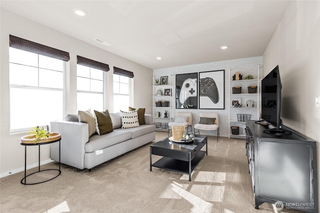 living area with a wealth of natural light, recessed lighting, visible vents, and built in features