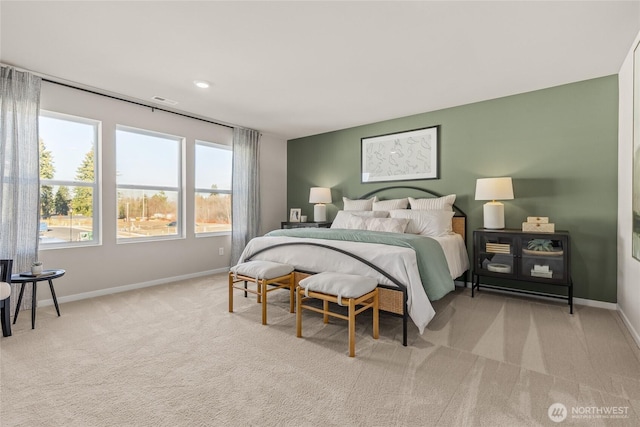 bedroom with carpet floors, visible vents, and baseboards