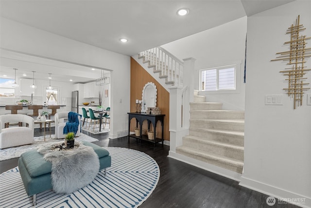 interior space featuring baseboards, stairway, wood finished floors, and recessed lighting