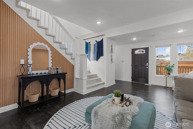 foyer entrance with baseboards, stairway, wood finished floors, and recessed lighting