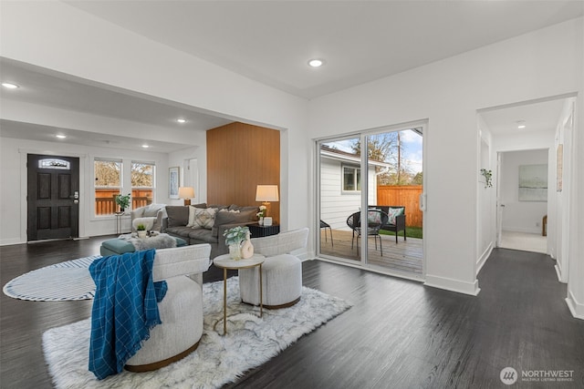 living room with baseboards, dark wood-type flooring, a wealth of natural light, and recessed lighting