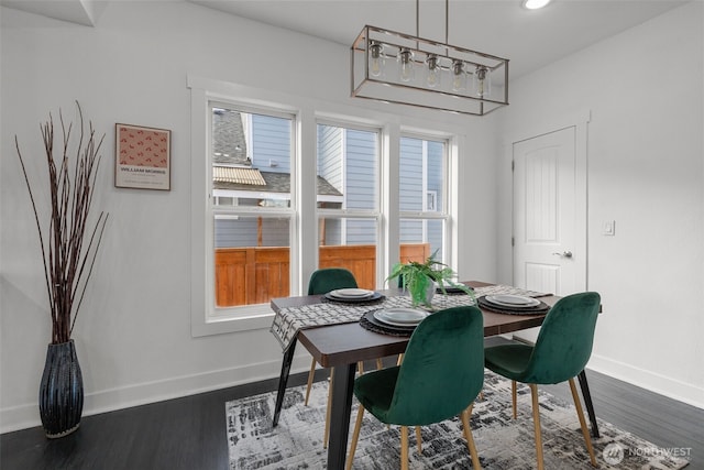 dining space featuring baseboards, dark wood finished floors, and recessed lighting