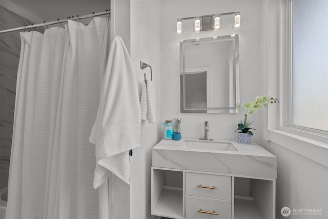 bathroom with curtained shower and vanity