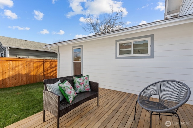 deck with a yard and fence