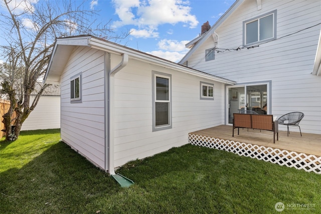 view of home's exterior with a lawn and a deck