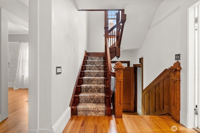 stairs with baseboards and wood finished floors