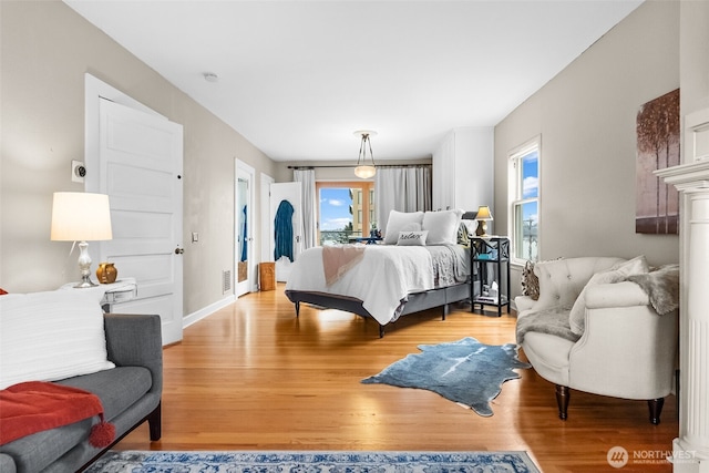 bedroom featuring light wood-style floors and baseboards