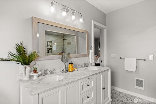 full bathroom with double vanity, a stall shower, a sink, and visible vents