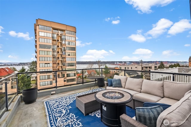 exterior space featuring an outdoor living space with a fire pit