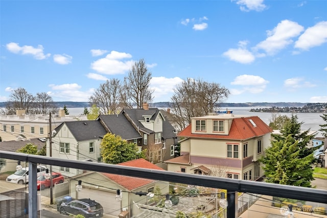 balcony featuring a water view and a residential view