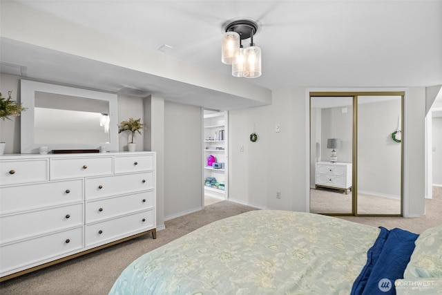 bedroom with baseboards, a closet, and light colored carpet