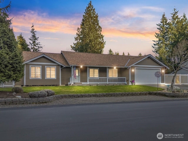 ranch-style house featuring roof with shingles, a porch, concrete driveway, a garage, and a lawn