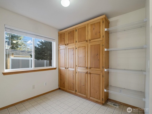 unfurnished bedroom with baseboards and visible vents