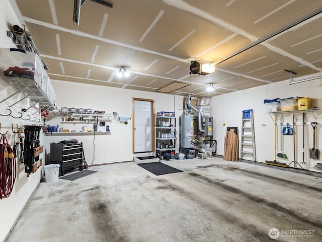 garage with a workshop area, a garage door opener, and water heater