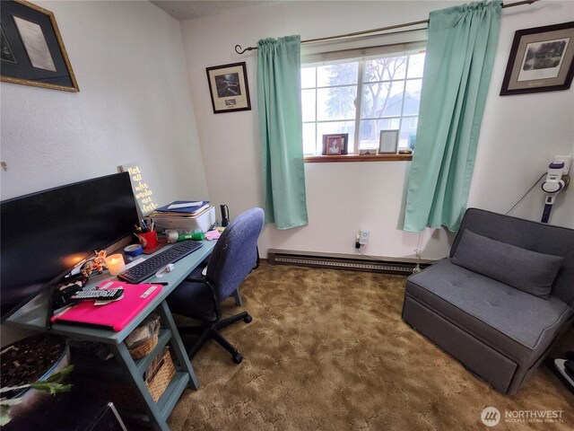 office space with a baseboard heating unit and carpet floors