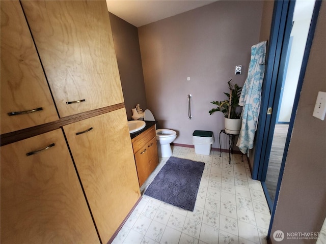 bathroom featuring tile patterned floors, baseboards, toilet, and vanity