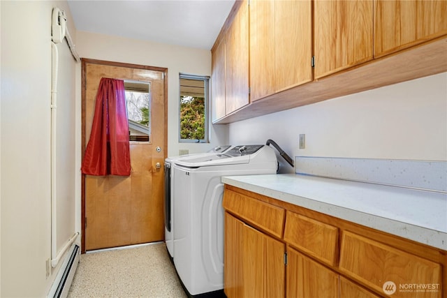 laundry area featuring baseboard heating, independent washer and dryer, and cabinet space