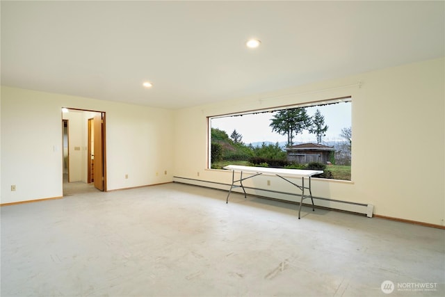 empty room featuring baseboards, concrete floors, a baseboard heating unit, and recessed lighting