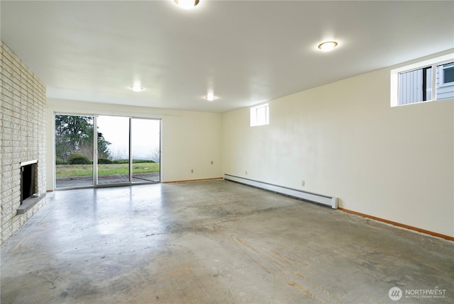 interior space with a baseboard heating unit, a brick fireplace, concrete flooring, and baseboards