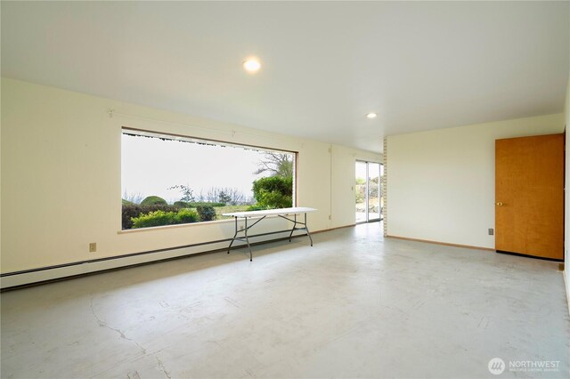 empty room featuring a baseboard radiator, concrete floors, baseboards, and recessed lighting