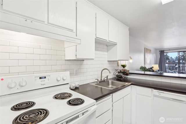 kitchen with tasteful backsplash, dark countertops, white appliances, white cabinetry, and a sink