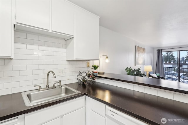 kitchen featuring a sink, decorative backsplash, white cabinets, dishwasher, and dark countertops