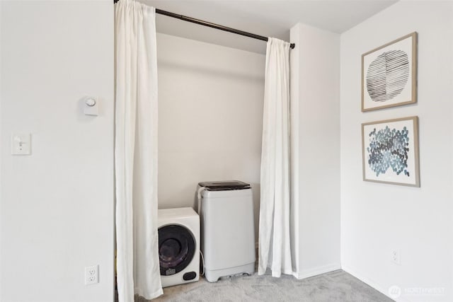 laundry room featuring carpet, washing machine and dryer, and laundry area