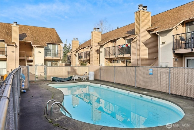 community pool with a residential view and fence