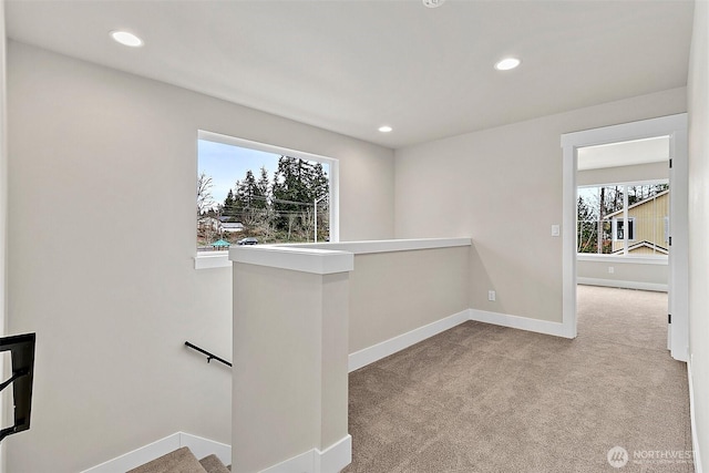 corridor with carpet floors, recessed lighting, an upstairs landing, and baseboards