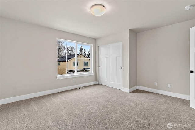 unfurnished bedroom with carpet, a closet, visible vents, and baseboards