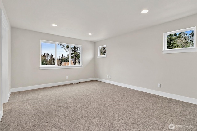 carpeted spare room with recessed lighting and baseboards