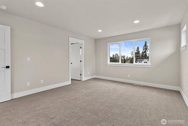 empty room with carpet, visible vents, baseboards, and recessed lighting