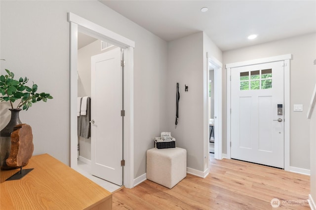 foyer entrance featuring light wood-style floors, recessed lighting, and baseboards