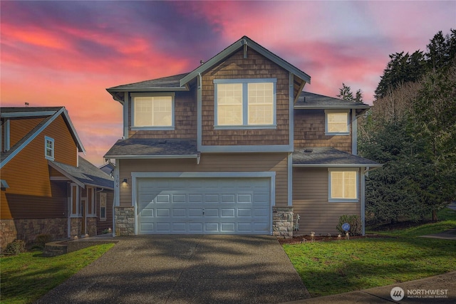 view of front of house with driveway, stone siding, a garage, and a front lawn