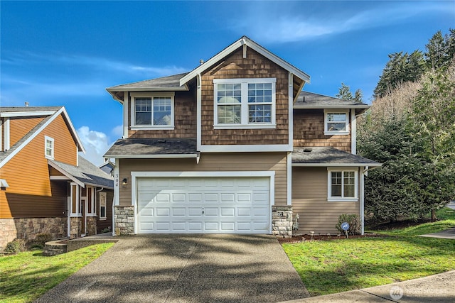 view of front facade featuring driveway, an attached garage, and a front yard