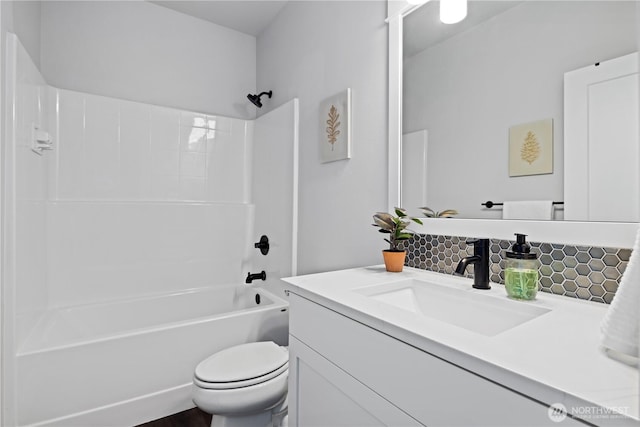 full bathroom with toilet, shower / tub combination, backsplash, and vanity