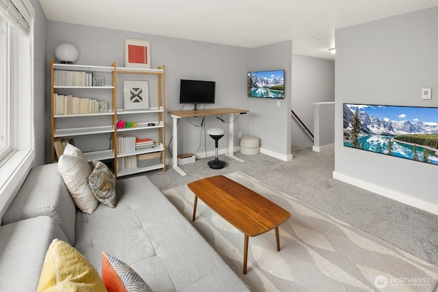 living room featuring carpet flooring and baseboards