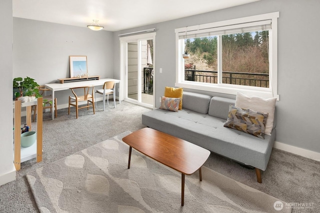 living room featuring carpet flooring and baseboards