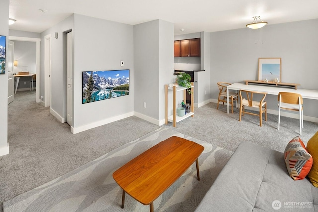 living room with light carpet and baseboards