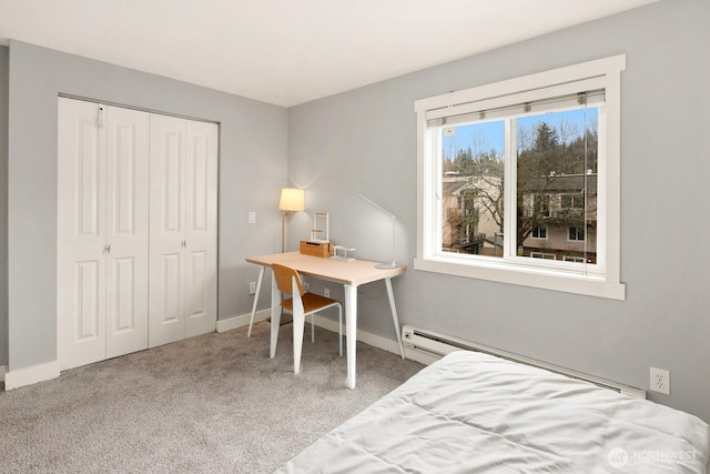 carpeted bedroom with baseboards, baseboard heating, and a closet