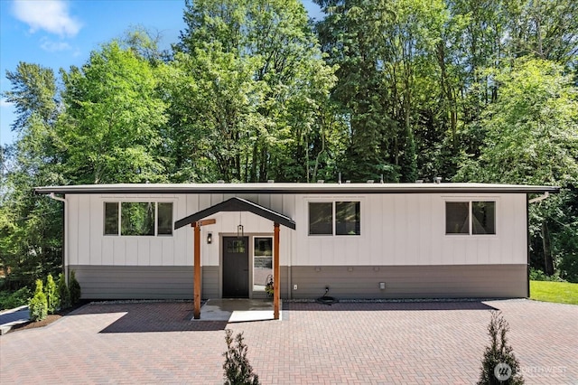 view of front of property with a patio and board and batten siding