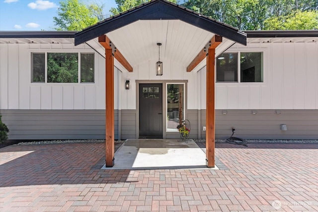 property entrance featuring board and batten siding