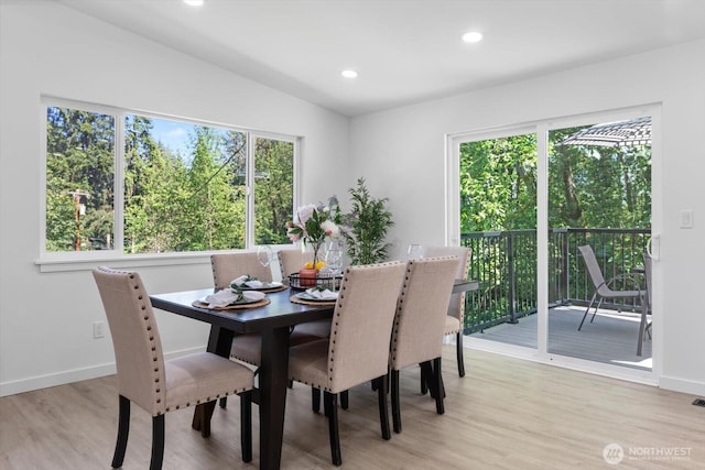 dining room featuring recessed lighting, baseboards, vaulted ceiling, and light wood finished floors