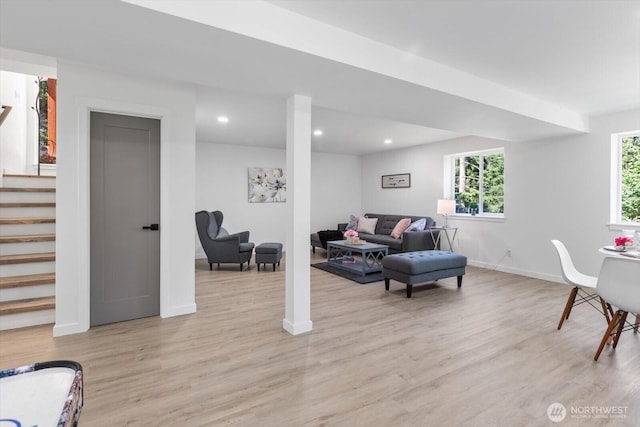 living area with light wood-style flooring, recessed lighting, stairway, and baseboards