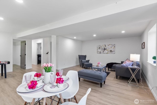 dining space featuring light wood-type flooring, washer / clothes dryer, and recessed lighting