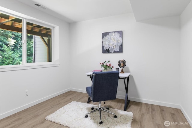 home office featuring baseboards, visible vents, and light wood-style floors