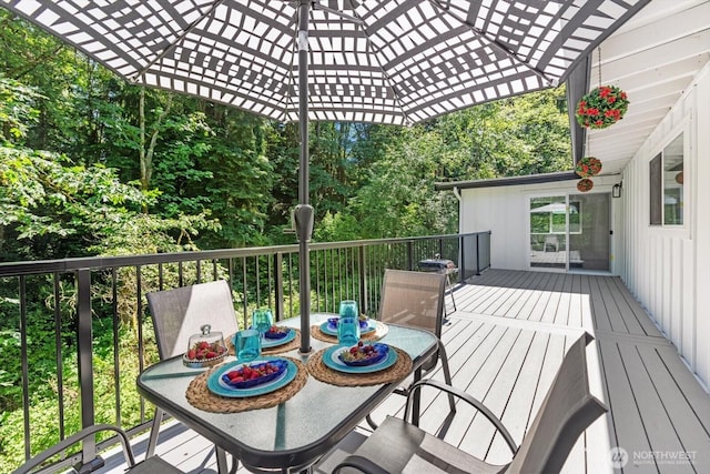 wooden terrace with outdoor dining area