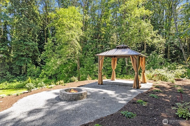 view of patio with an outdoor fire pit and a gazebo